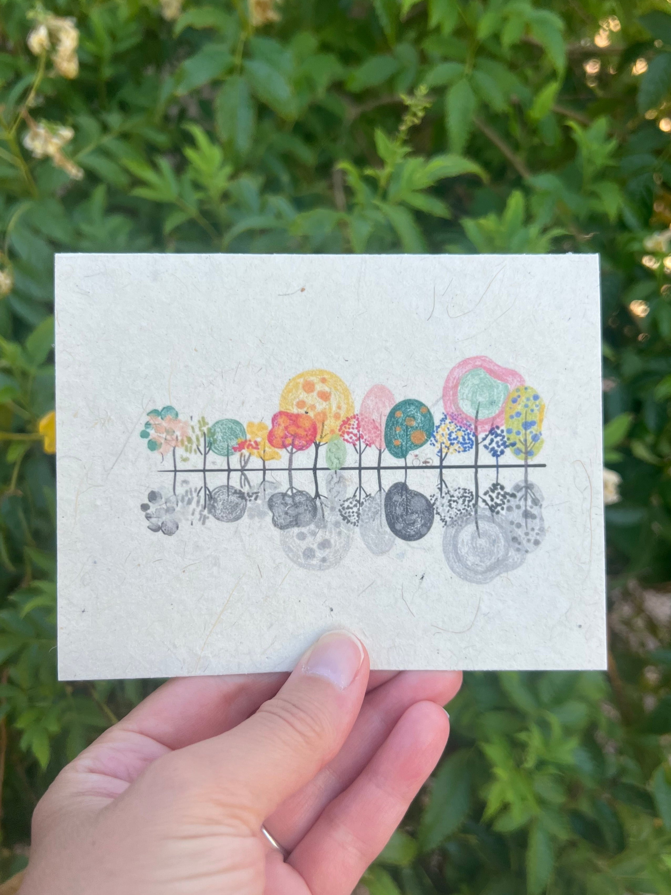 seed paper card with beautiful colorful trees with silhouette and a bike