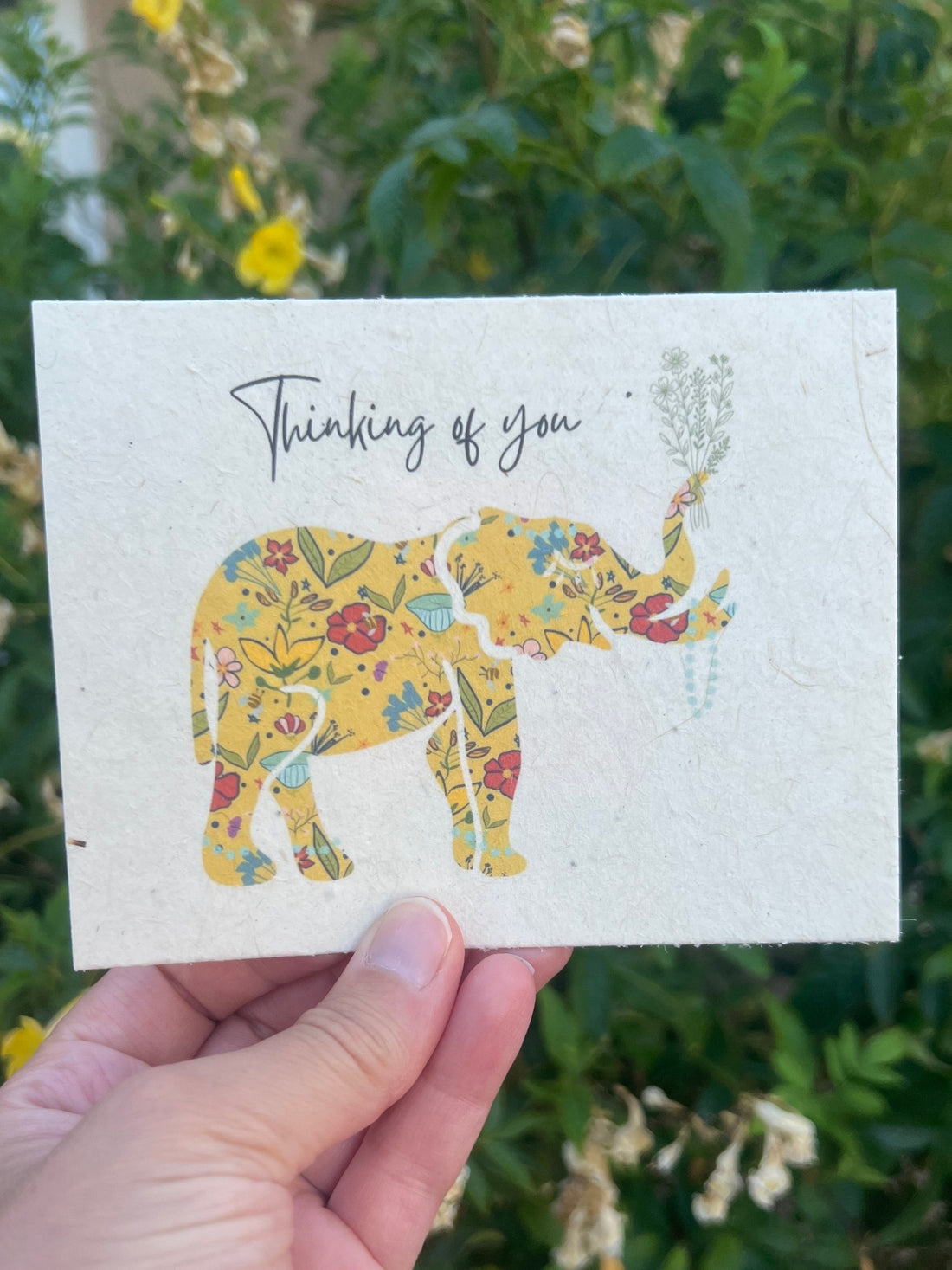 seed paper card with colorful elephant holding a bouquet of flowers saying thinking of you