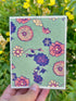 mint green with pink and purple flowers on a plantable seed paper greeting card